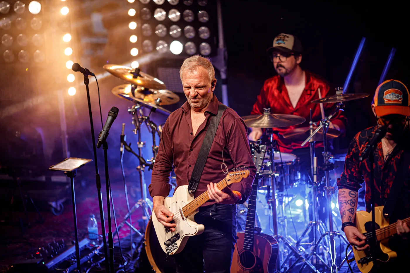 A rock band’s guitarist and drummer on stage at Lindholmen Street Food Market, Gothenburg