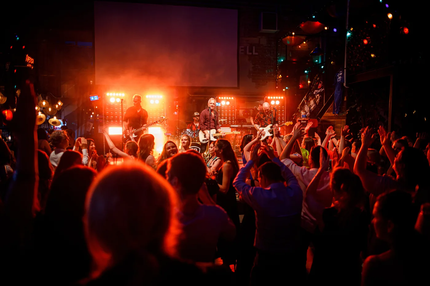 A crowd with raised hands at a rock concert at Lindholmen Street Food Market, Gothenburg