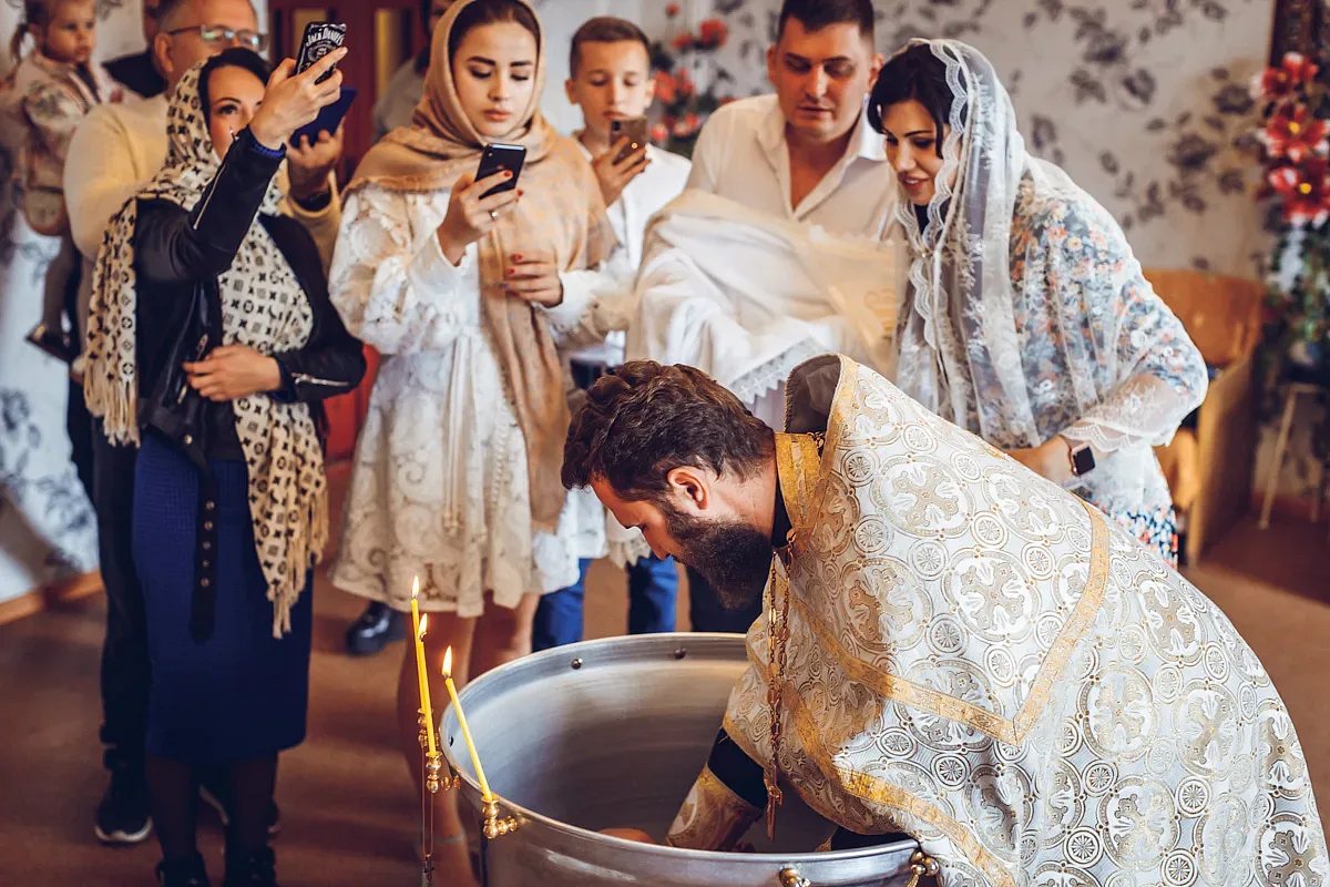 Relatives around the font during the sacrament