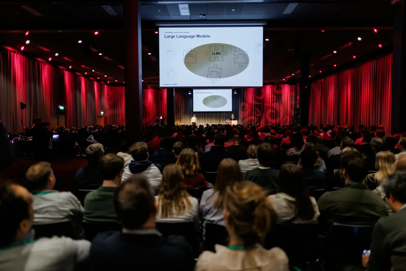 Full conference hall during a talk on large language models
