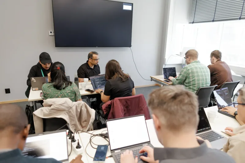 Workshop participants working on laptops in small groups