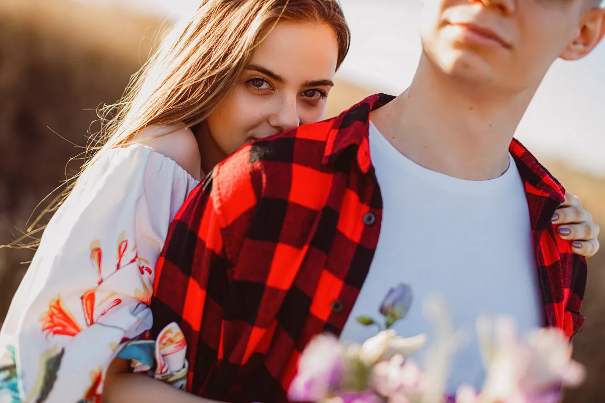 Woman hugging a man in a checked shirt