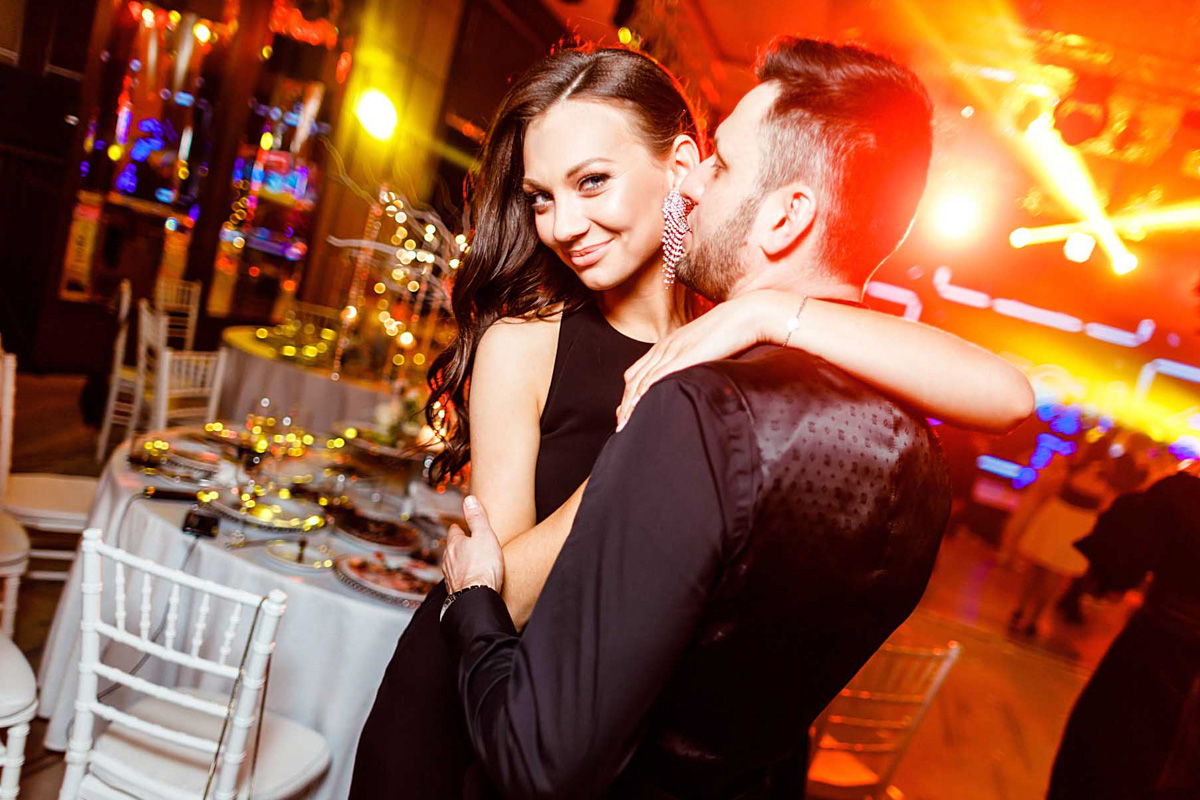 Corporate event in a conference room with professional lighting setup and attendees listening to the speaker