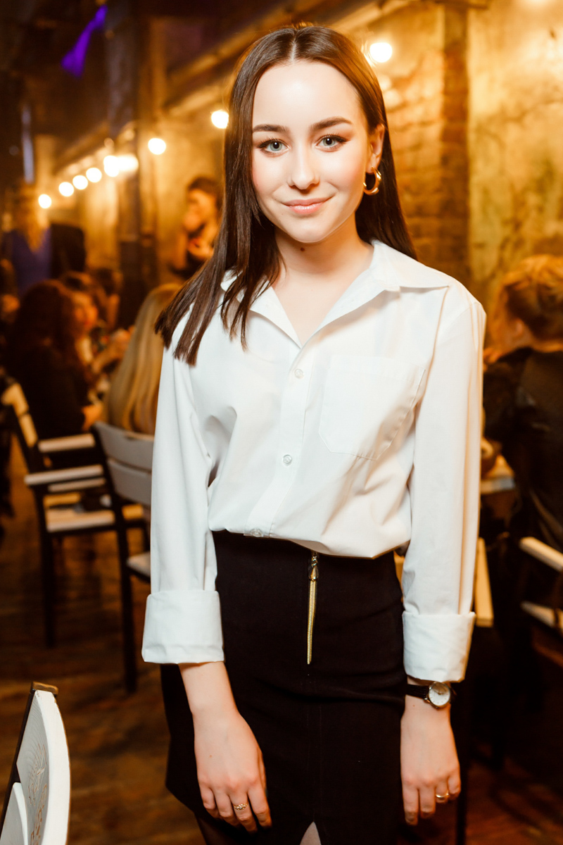 Photographer using flash to capture vibrant moments at a corporate seminar event, attendees networking in the background