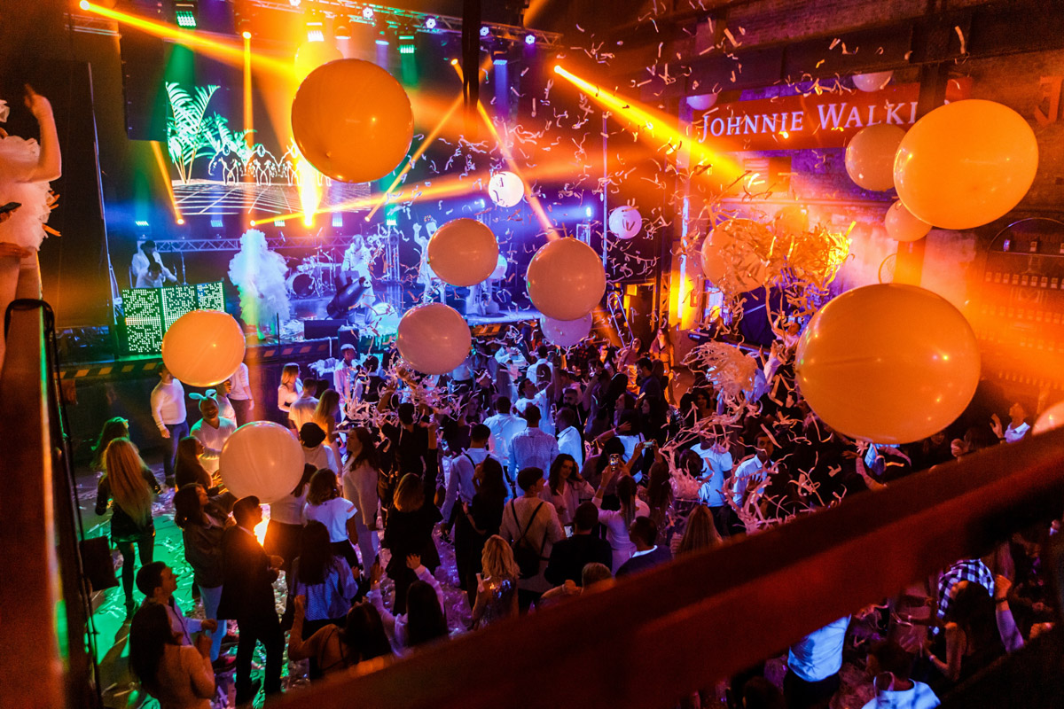 Conference attendees networking in a bright, modern event space during a business seminar