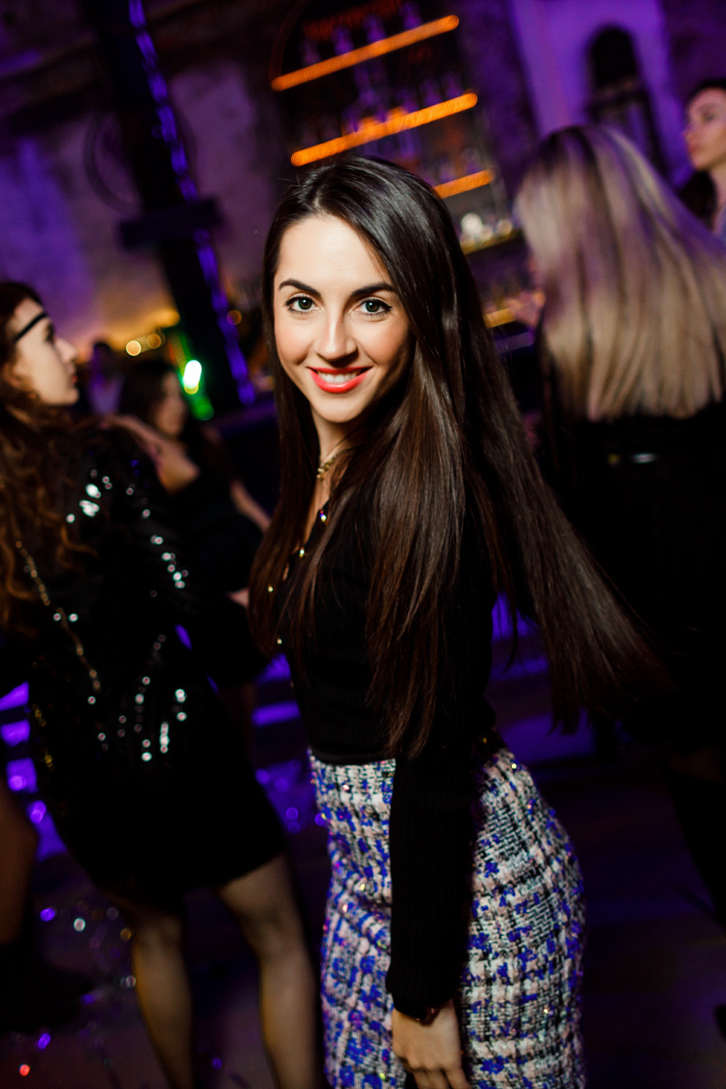 Event venue with photographers using flash to capture candid moments at a professional corporate gathering