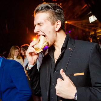 Corporate conference with vibrant lighting and flash photography capturing event moments and speaker sessions