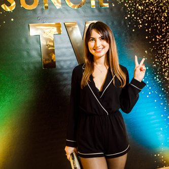 Event photography capturing a lively business event with speakers and audience in a well-lit conference room