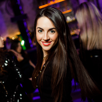Photographer capturing event guests in a business conference room with bright artificial lighting and flash used