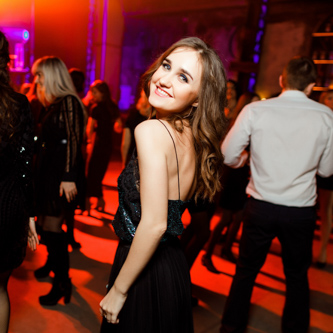 Flash photography capturing event guests at a corporate seminar during professional networking sessions