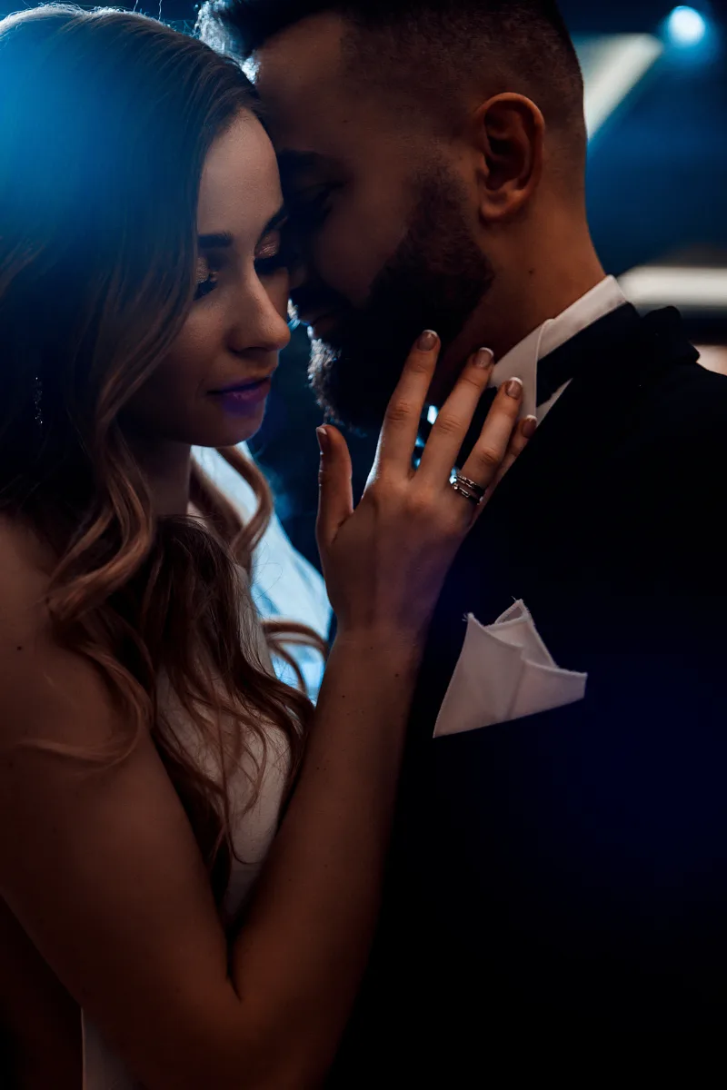 Couple dancing close in the dark, the ring in frame