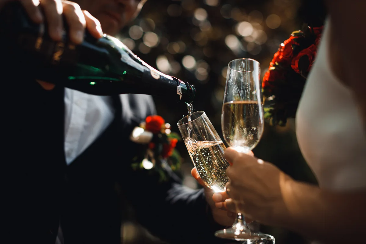 Champagne being poured into glasses at the wedding dinner