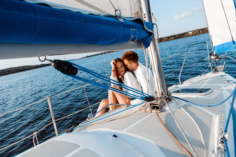 Couple sitting close together on a sailing boat