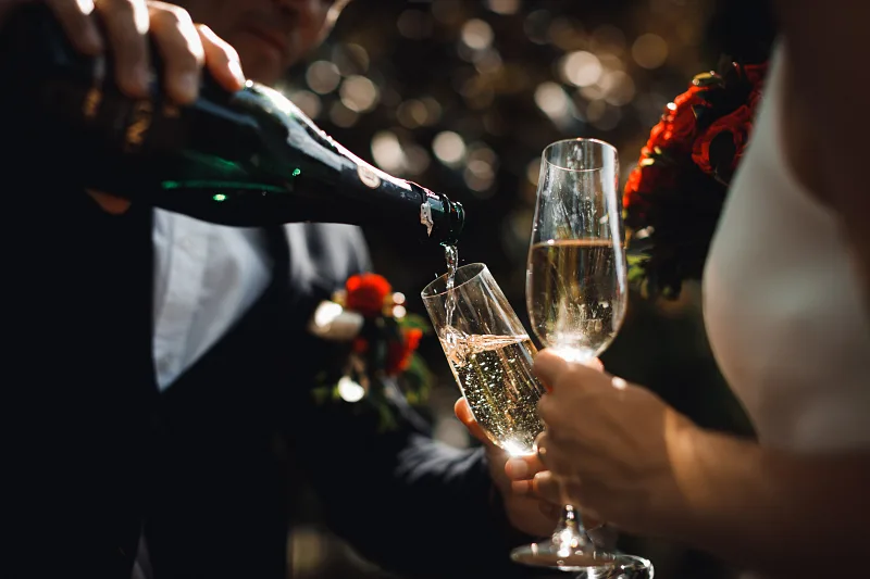 Champagne being poured into glasses at the wedding dinner